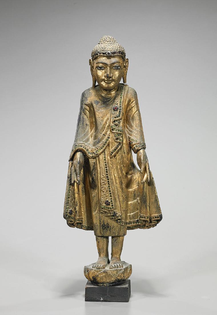 Antique Burmese Gilt Wood Buddha: Antique Burmese gilt wood Buddha; decorated with colorful 'jewels'; standing atop a lotus base; H: 24" (approx.)