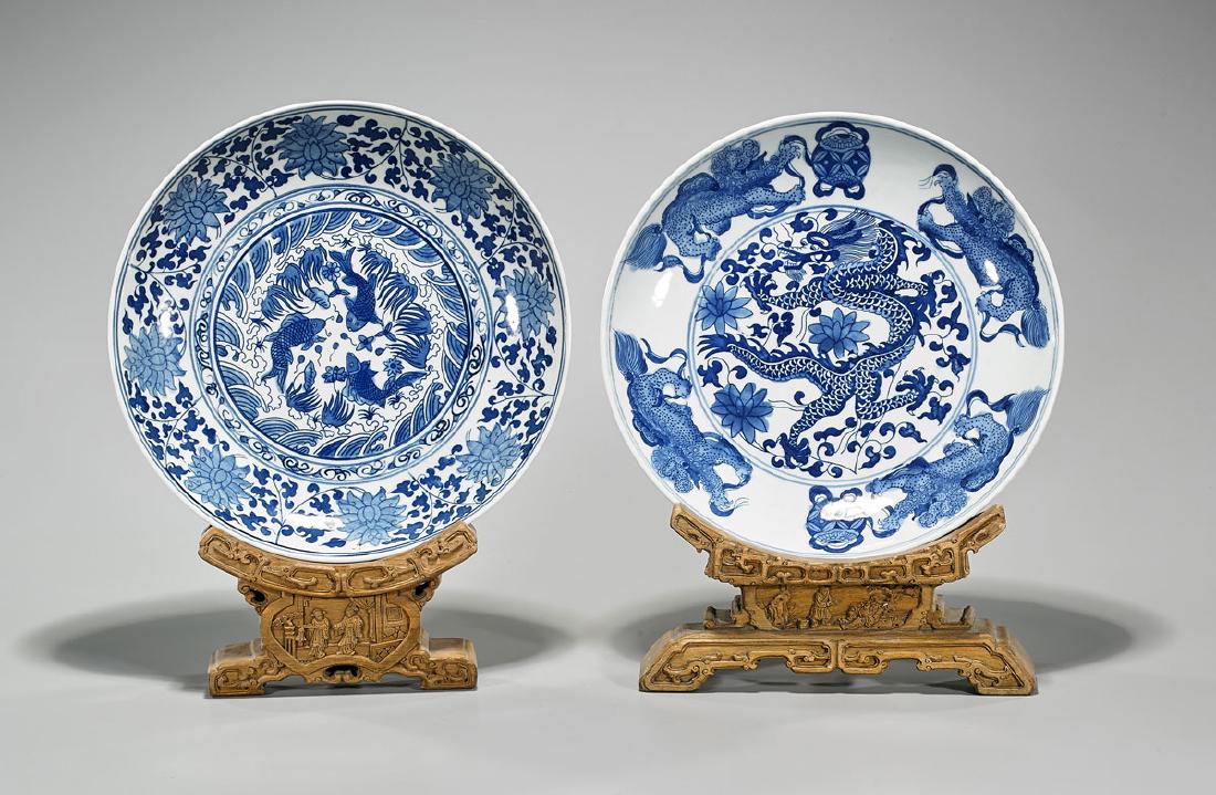Two Chinese Blue & White Porcelain Dishes: Two Chinese blue and white porcelain dishes; each with Wanli mark, but later; Provenance: Collection of John B. Wickman; D: 11 3/4" (widest, approx.); wood stands