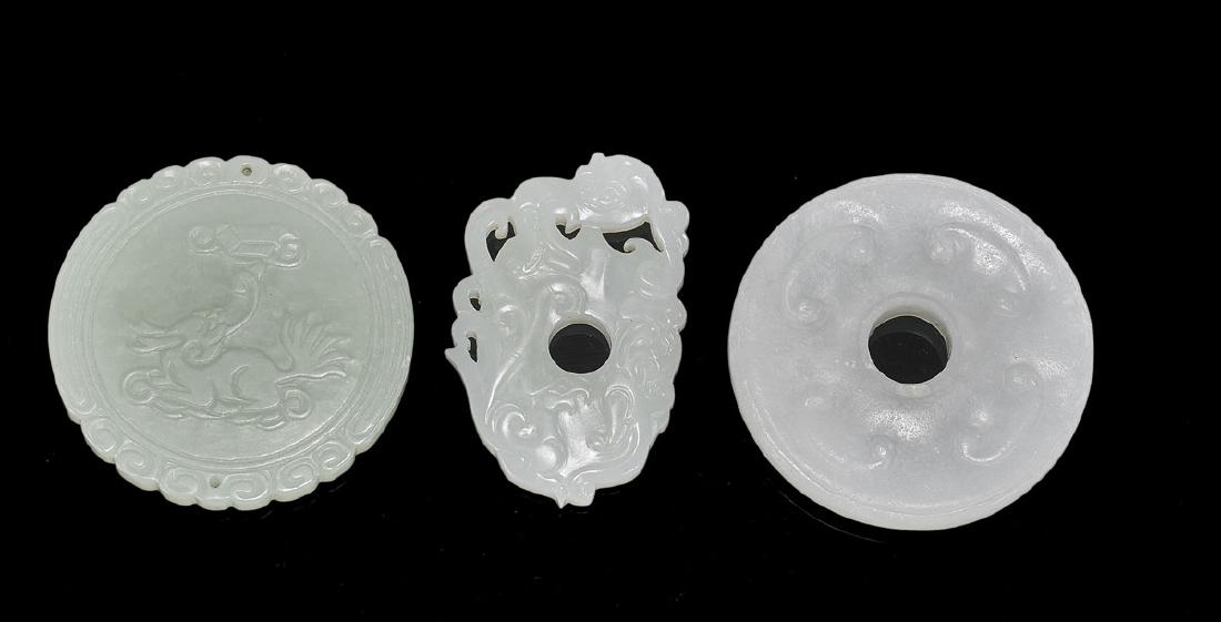 Three Chinese Carved Jade Pieces: Three Chinese carved jade pieces: two plaques; together with bi disc; D: 2 1/8" (widest, approx.)