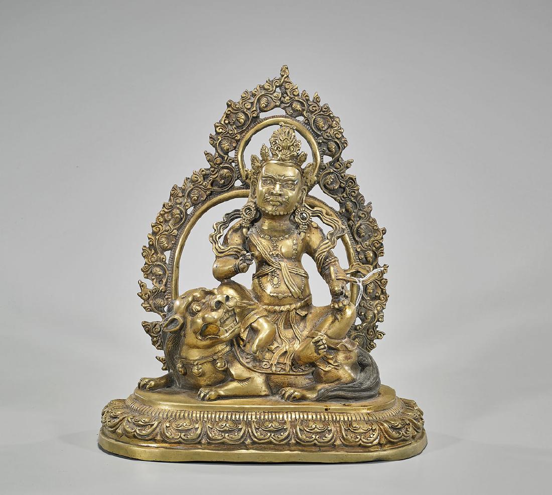 Chinese Ming-Style Gilt Bronze Seated Deity: Chinese Ming-style gilt bronze deity; seated atop a lion, before a scrolling mandala; all upon a lotus base; Xuande mark to verso, but later; H: 13 1/4" (approx.)