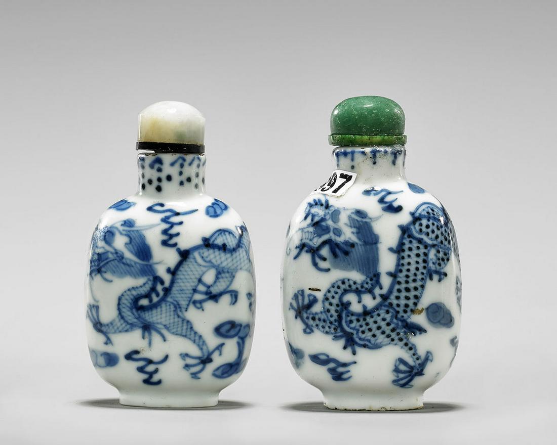 TWO BLUE & WHITE PORCELAIN SNUFF BOTTLES: Two Chinese blue & white porcelain snuff bottles; each of ovoid form with dragon design; one hardstone and one jadeite stopper; Provenance: the Estate of Ted Adameck; H: 2 1/2" (taller)