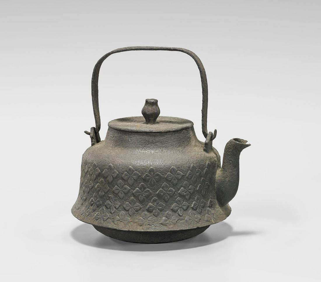 JAPANESE IRON TEAPOT: Japanese iron teapot; decorated with floral medallions in light relief; 19th Century or earlier; H: 8" (overall)