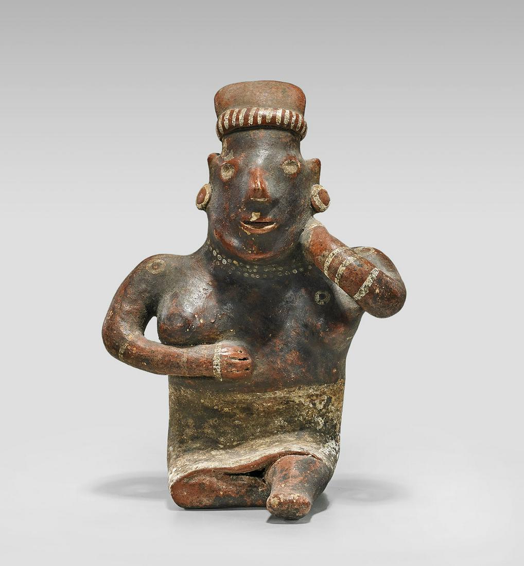 JALISCO SEATED FEMALE FIGURE: Pre-Columbian Jalisco seated female figure; showing white painted decoration; circa 200 B.C.-400 A.D.; H: 9 1/2"; Provenance: Collection of Dr. Donald Feigelson; with appraisal by Sidney Newman, E