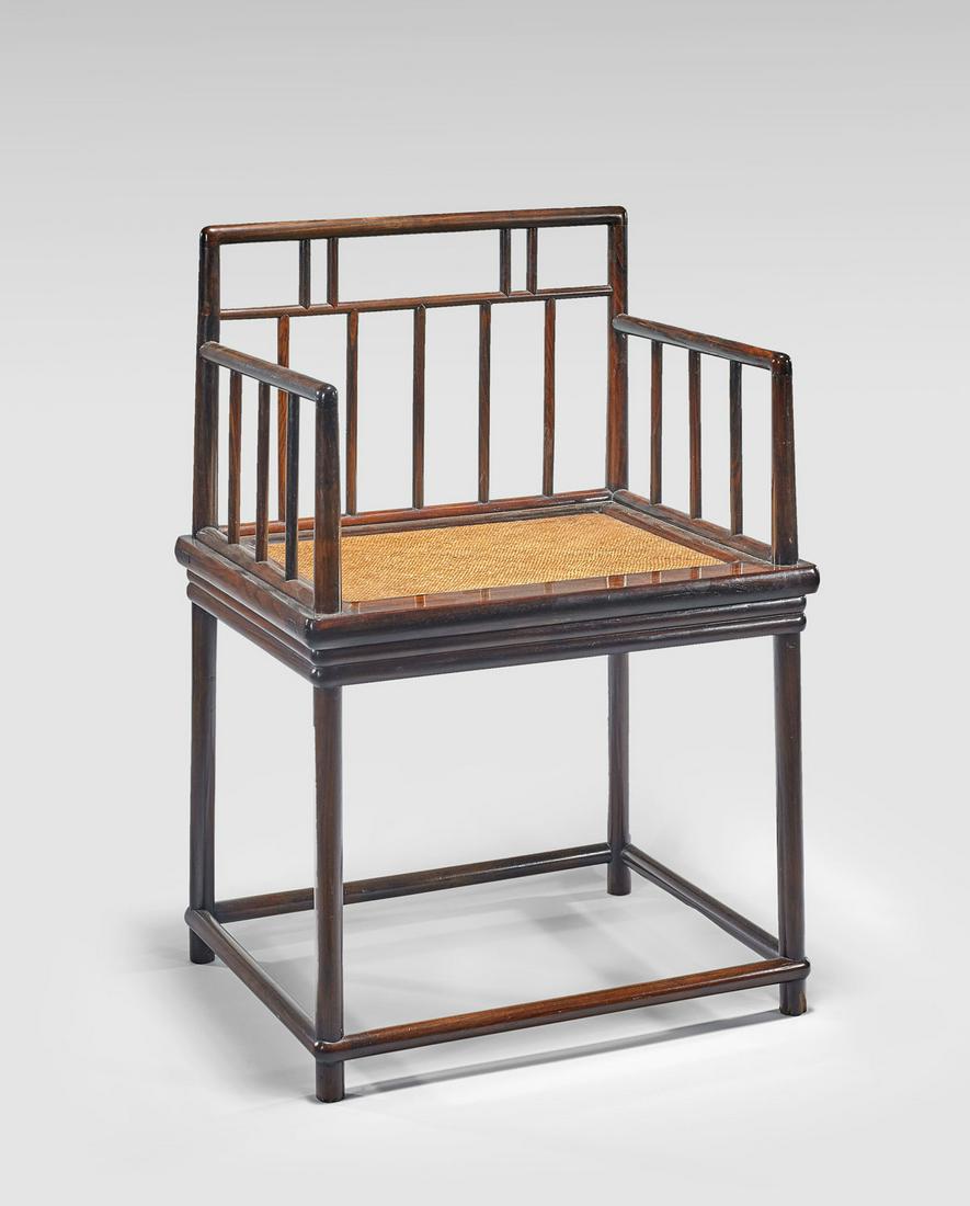 CHINESE HARDWOOD ARMCHAIR: Chinese hardwood armchair; the rectilinear frame enclosing spindled back and arms; with caned seat; H: 33 1/4" x W: 22 1/2" x D: 18" (approx.)