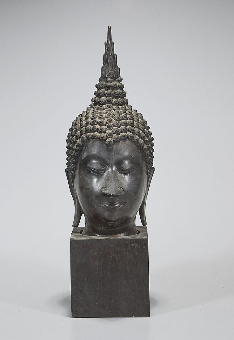 Antique Thai Bronze Head of Buddha: Antique Thai bronze head of Buddha; Provenance: the Estate of Ted Adameck; H: 12" (approx.); wood stand