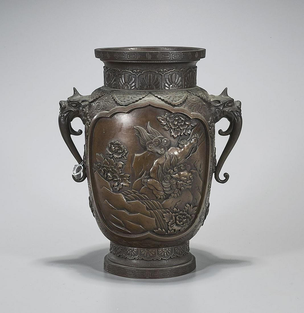 Japanese Bronze Vase: Japanese bronze vase; with panels of shi-shi amid flowers on a scrolling floral ground, flanked by mask handles; mark to base; Provenance: the Estate of Ted Adameck; H: 14" (approx.)