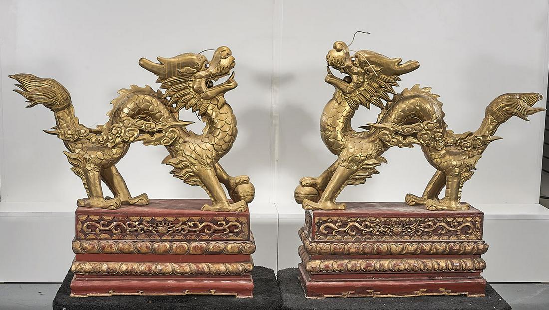 Pair Chinese Gilt Wood Carved Dragons: on decorative bases; 35" x 32" x 9" (each, approx.). condition: wear, cracks, chips, minor losses. This item is sold as-is with all defects and faults. Any note on condition is not a guarantee that ad