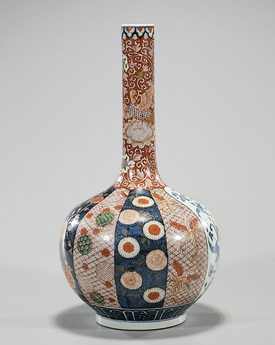 Chinese Red and Blue Porcelain Vase: Chinese slender neck porcelain vase with floral designs; hallmark to base; 16 1/2" x 9" (approx.) Condition: general wear, frits, pits