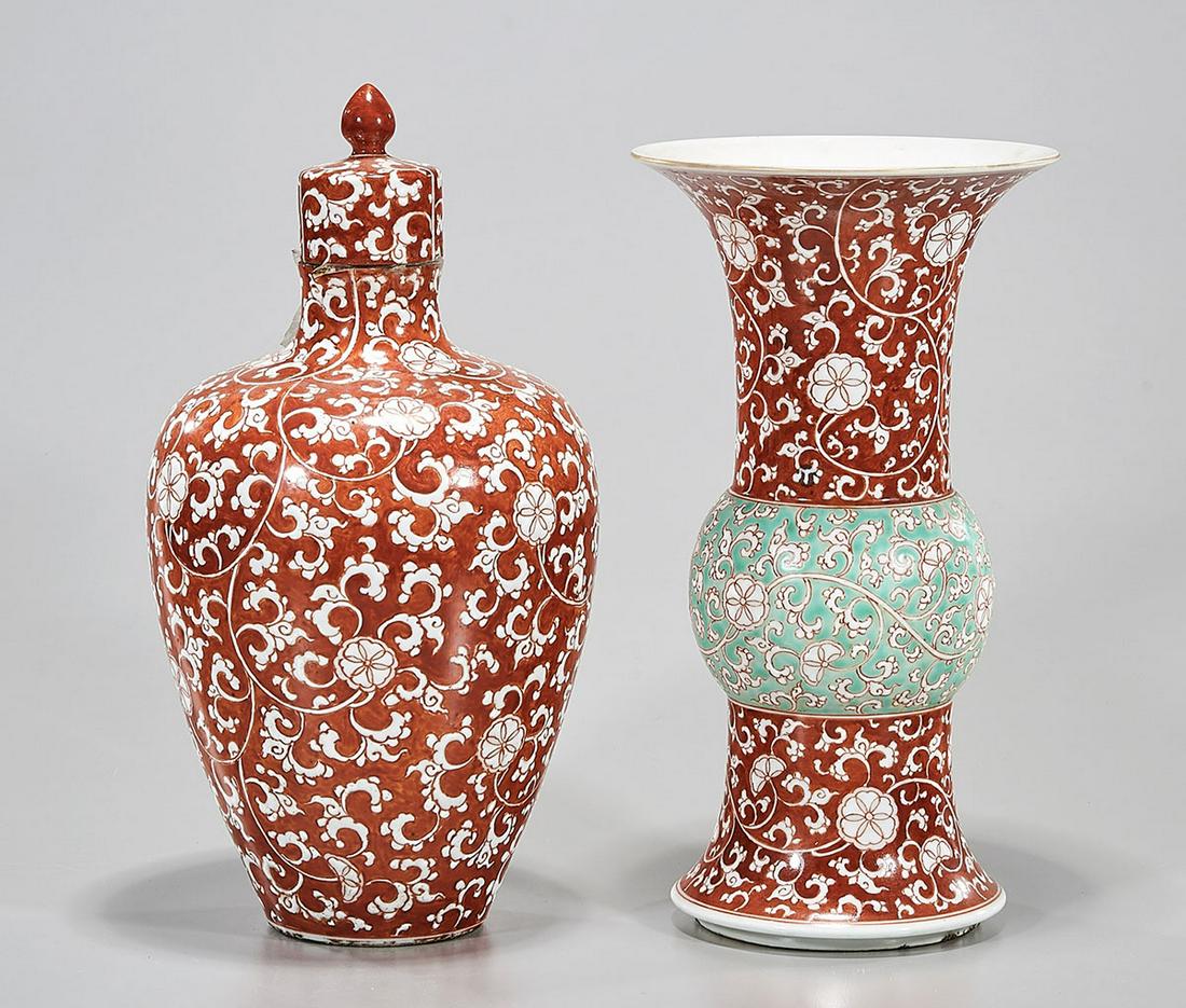 Two Chinese Coral Red Porcelains: Two Chinese coral red porcelain vases; one with cover; 10 1/2" x 6" (larger, approx.) Condition: general wear, frits, pits