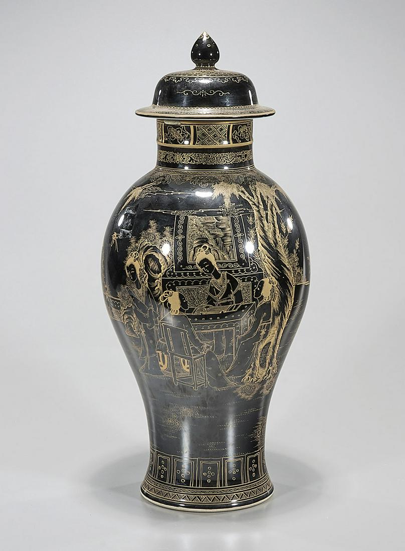 Chinese Black Glazed Porcelain Vase: Chinese black porcelain vase with gilt figures in domestic setting and landscape motif; Qianlong mark but later; 19 1/2" x 9" (approx.) Condition: general wear, frits, pits