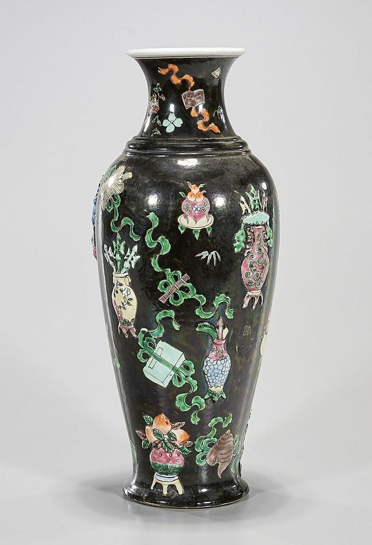 Chinese Enameled Porcelain Vase: Chinese enamel molded black ground vase with still life motifs; 14" x 6" (approx.) Condition: general wear, frits, pits, minor chips
