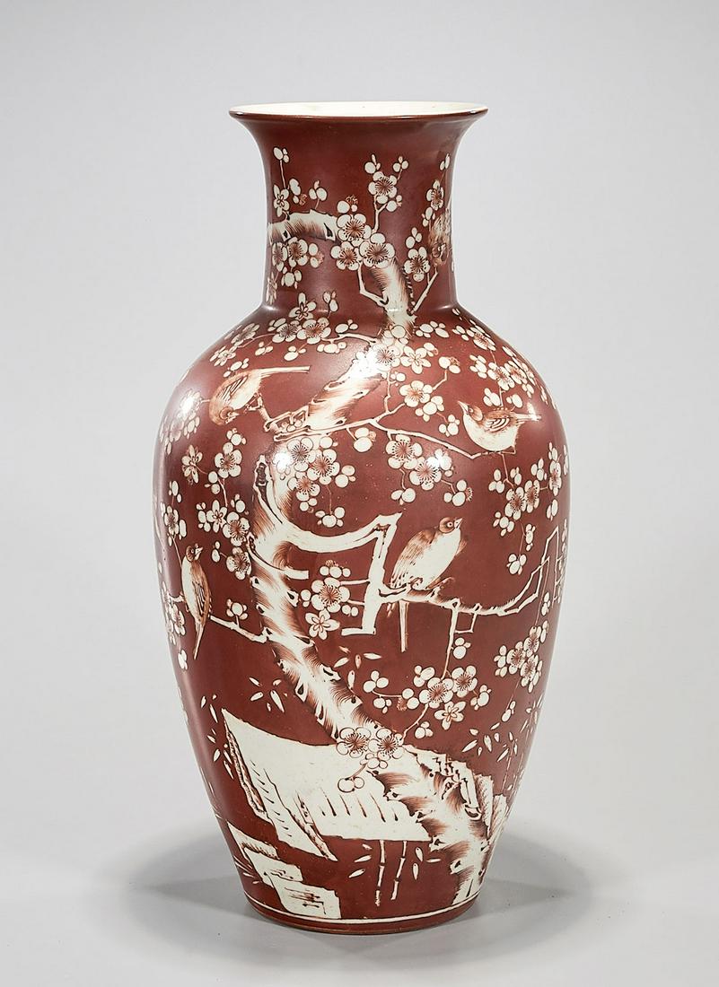 Chinese Enameled Porcelain Vase: Chinese red coral glazed vase; blossoming branches and bird design; 18" x 8" (approx.) Condition: general wear, frits, pits, minor chips