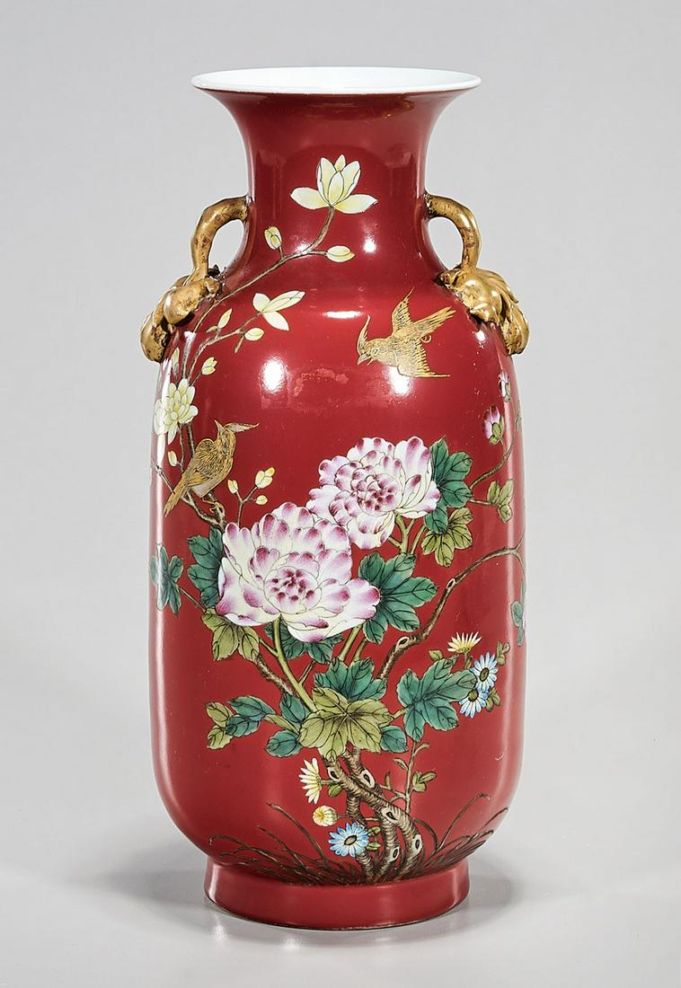 Chinese Enameled Porcelain Vase: Chinese enameled porcelain red ground vase; floral and bird decoration; gilt handles; 12" x 6" (approx.) Condition: general wear, frits, pits, minor chips