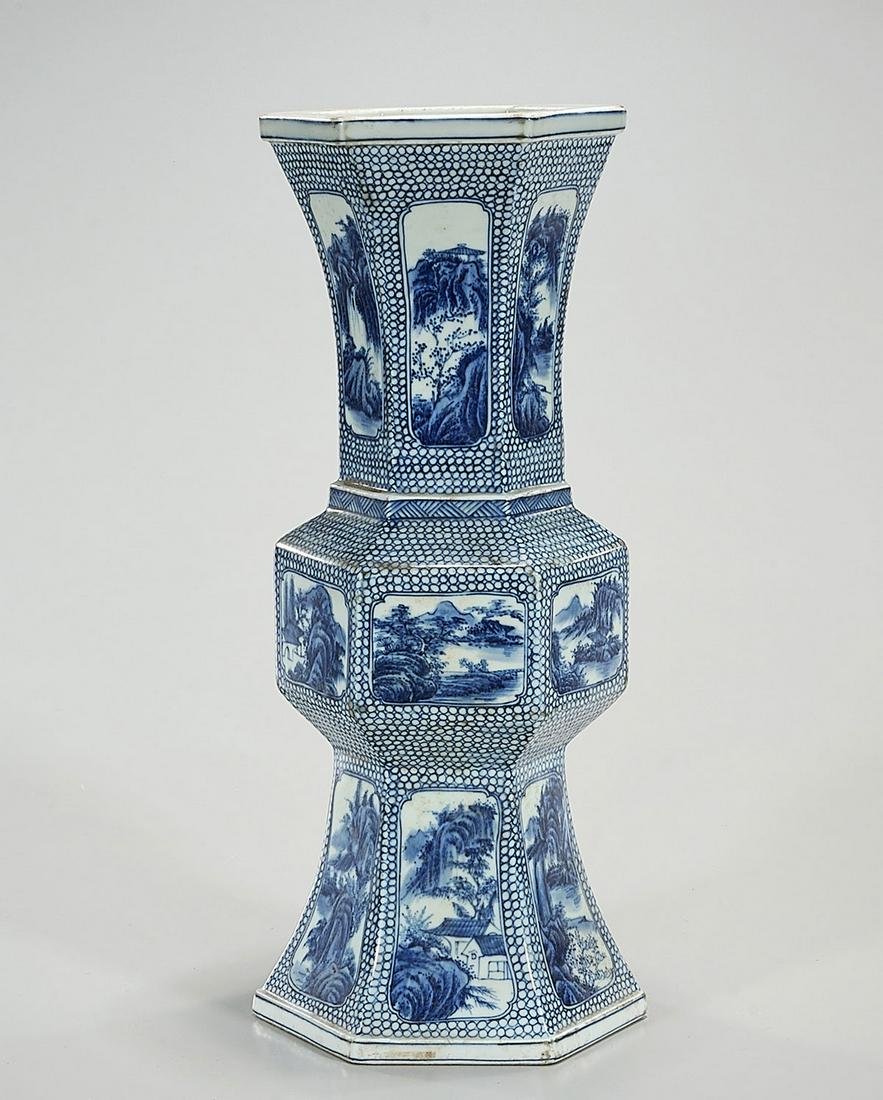 Chinese Blue and White Porcelain Gu Form Vase: Chinese blue and white porcelain gu form vase with landscape motifs; 15" x 6" (approx.) Condition: general wear, frits, pits, minor losses