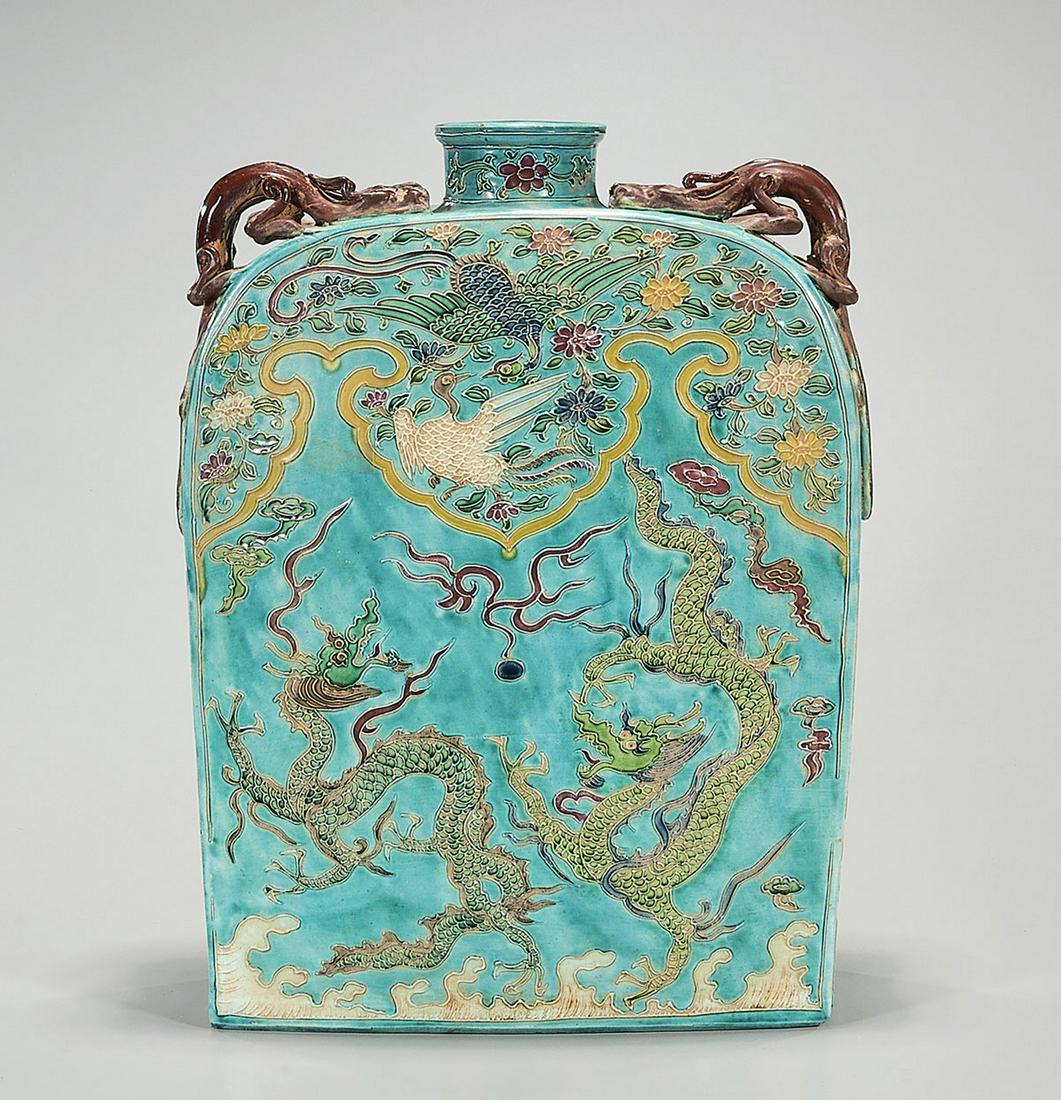 Chinese Enameled Porcelain Flask: Chinese enameled porcelain flask; turquoise glaze; raised animal forms to shoulder; dragon chasing pearls motif; 15" x 10" x 4" (approx.) Condition: general wear, frits, pits, minor losses