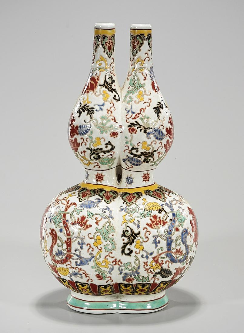 Chinese Enameled Porcelain Double Gourd Vase: Chinese enameled porcelain double neck double gourd vase; floral design; mark to base; 14" x 8" x 6 1/2" (approx.) Condition: general wear, frits, pits, minor losses
