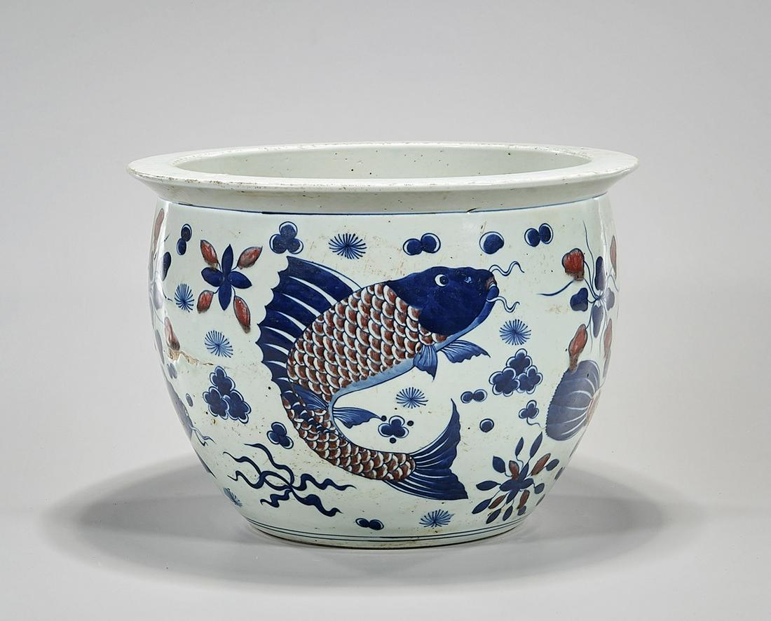Chinese Red, Blue and White Porcelain Jardiniere: Chinese red, blue and white jardiniere with fish motif; 9" x 12 1/2" (approx.) Condition: general wear, frits, pits, minor losses