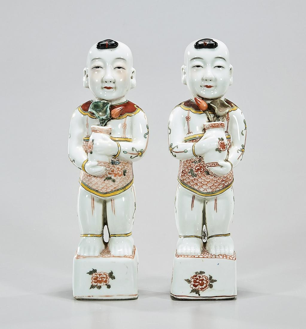 Pair Chinese Enameled Porcelain Children Figures: Pair of Chinese enameled porcelain figures of children holding flower vases; 10 1/2" x 2 1/2" sq. (each, approx.) Condition: general wear, frits, pits, minor losses