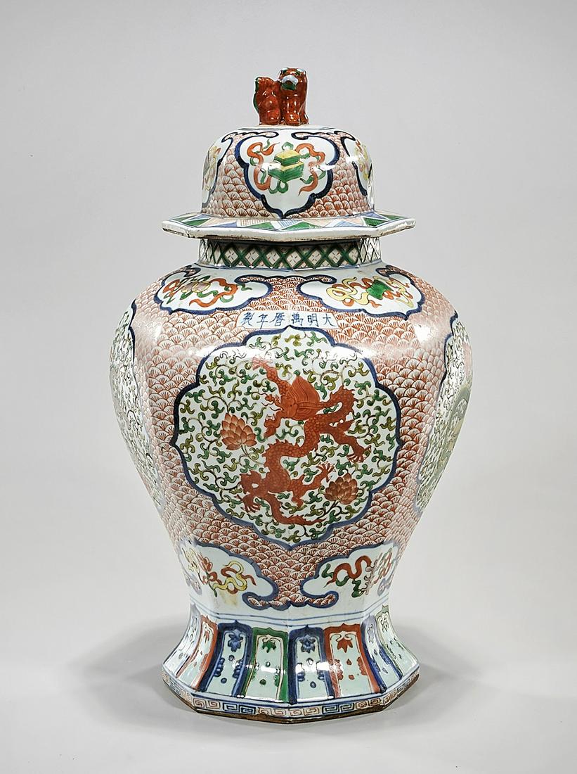 Chinese Wucai Porcelain Covered Vase: Chinese wucai porcelain covered octagonal vase; dragon design; 21" x 8" (approx.) Condition: general wear, frits, pits, minor losses
