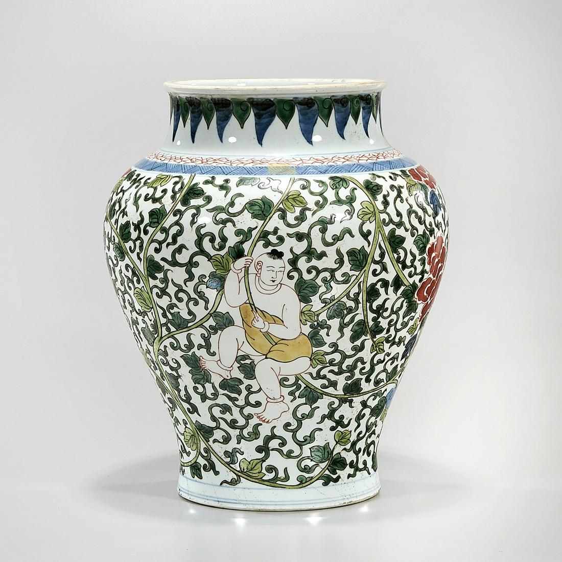 Chinese Enameled Porcelain Vase: Chinese enameled porcelain vase; flower and foliage decoration; concentric rings to base; 12" x 10" (approx.) Condition: general wear, frits, pits, minor losses