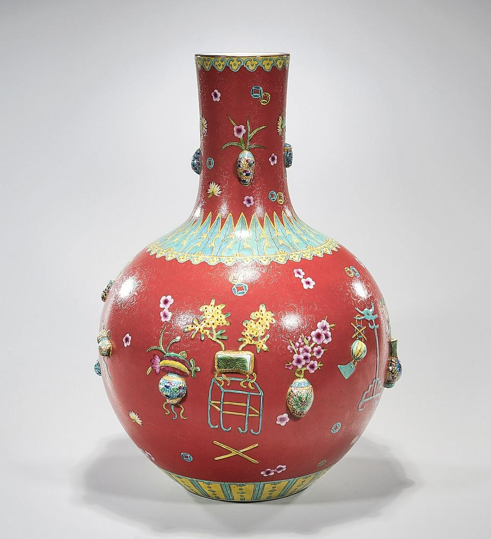 Tall Chinese Enameled Porcelain Vase: Tall Chinese enameled porcelain globular vase; red glaze with enamel and mold flower still life motifs; Qianlong mark but later; 22 1/4" x 16 1/2" (approx.) Condition: wear, frits, pits, minor loss
