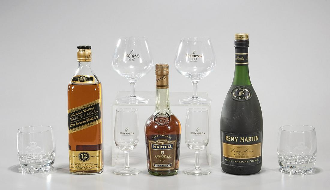 Group of Cognacs and Scotch: Two bottles of cognac- Martel VS and Remy Martin VSOP, and a bottle of Johnny Walker Black; along with six various glasses