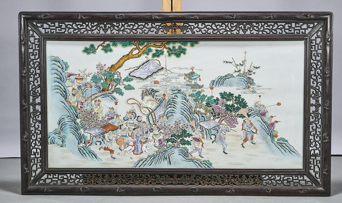 Chinese Framed Enameled Porcelain Plaque: Chinese framed enameled porcelain plaque; procession of figures in a landscape; carved openwork frame; 21 1/2" x 43" (sight, approx.) Condition: wear, frits, pits, minor loss
