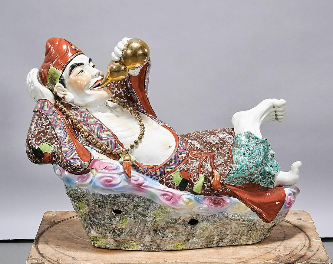 Chinese Enameled Porcelain Figure: Chinese enameled porcelain reclining figure; 17 1/2" x 23" x 10" (approx.) Condition: wear, frits, pits, losses