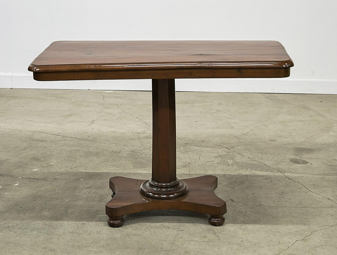 Antique Walnut Regency Side Table: Antique walnut side table with rectangular top with molded edge and rounded corners, above a conforming frieze; resting on an octagonal pedestal terminating on a quatrefoil base raised on four turned