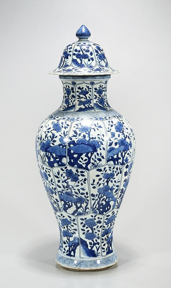 Tall Chinese Blue & White Porcelain Covered Vase: Tall Chinese blue and white porcelain covered vase; floral design; 22" x 9" (approx.) Condition: wear, frits, pits, minor loss