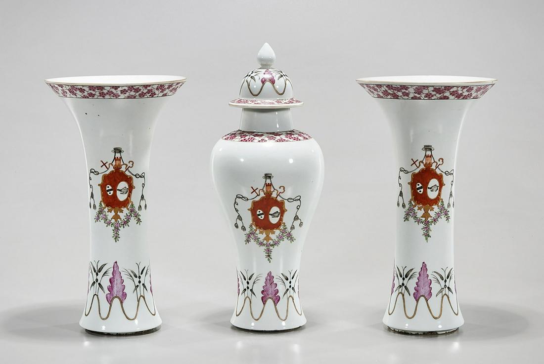 Group of Three Chinese Enameled Porcelain Vases: Three Chinese enameled porcelain vases; including a covered vase and two gu-form; heraldic design; 13" x 5" (tallest, approx.) Condition: wear, frits, pits, minor loss; chip to mouth under lid