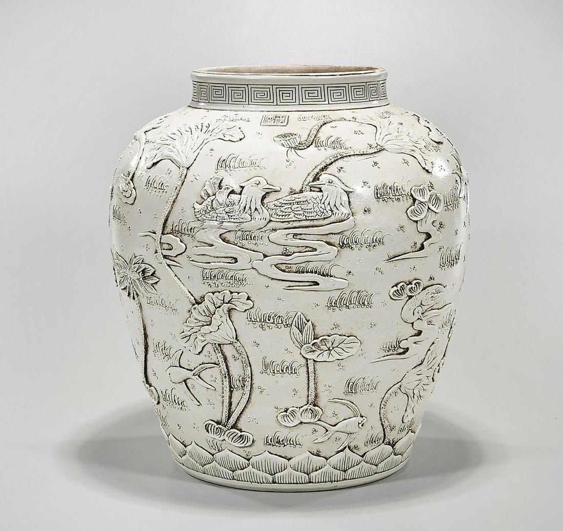 Chinese Glazed Porcelain Jar: Chinese carved enamel glazed porcelain jar; depicting a pond scene; 15" x 16" (approx.) Condition: wear, frits, pits, minor loss