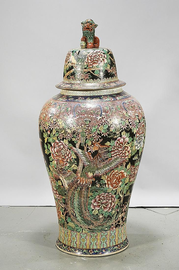 Large Chinese Enameled Porcelain Covered Vase: Large Chinese enameled porcelain covered vase; phoenix with flowers and pond motif; lion finial; 44" x 21" (approx.) Condition: wear, frits, pits, minor loss