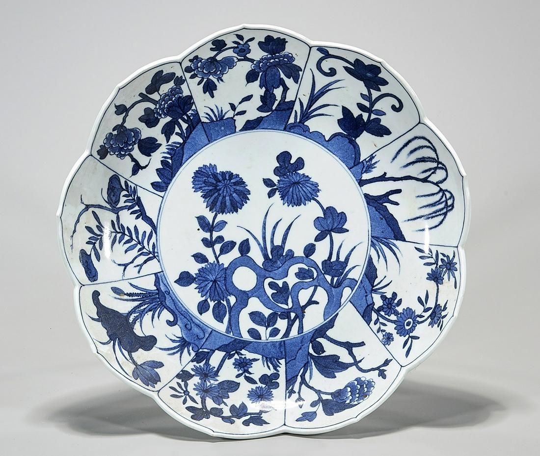Chinese Large Blue and White Porcelain Dish: Chinese large petal form porcelain dish with fruit and floral motif; D: 13" (approx.) Condition: general wear, frits, pits