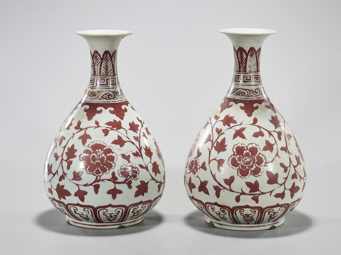 Pair Chinese Red and White Yuhuchun Porcelain Vases: Pair of Chinese Yuhuchun porcelain vases, scrolling floral design; 13" x 8" (each, approx.) Condition: general wear, possible restoration, minor chips, frits, pits