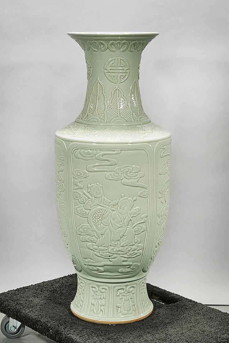Tall Chinese Celadon Glazed Porcelain Vase: Tall Chinese celadon glazed porcelain vase; molded figural design; 36 1/2" x 15" (approx.) Condition: wear, frits, pits, minor loss