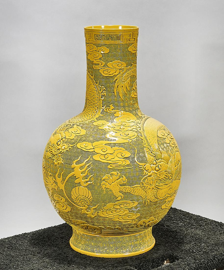 Tall Chinese Yellow Glazed Porcelain Vase: Tall Chinese yellow glazed porcelain vase; molded dragon chasing pearls motif; Qianlong mark but later; 26" x 15" (approx.) Condition: wear, frits, pits, minor loss