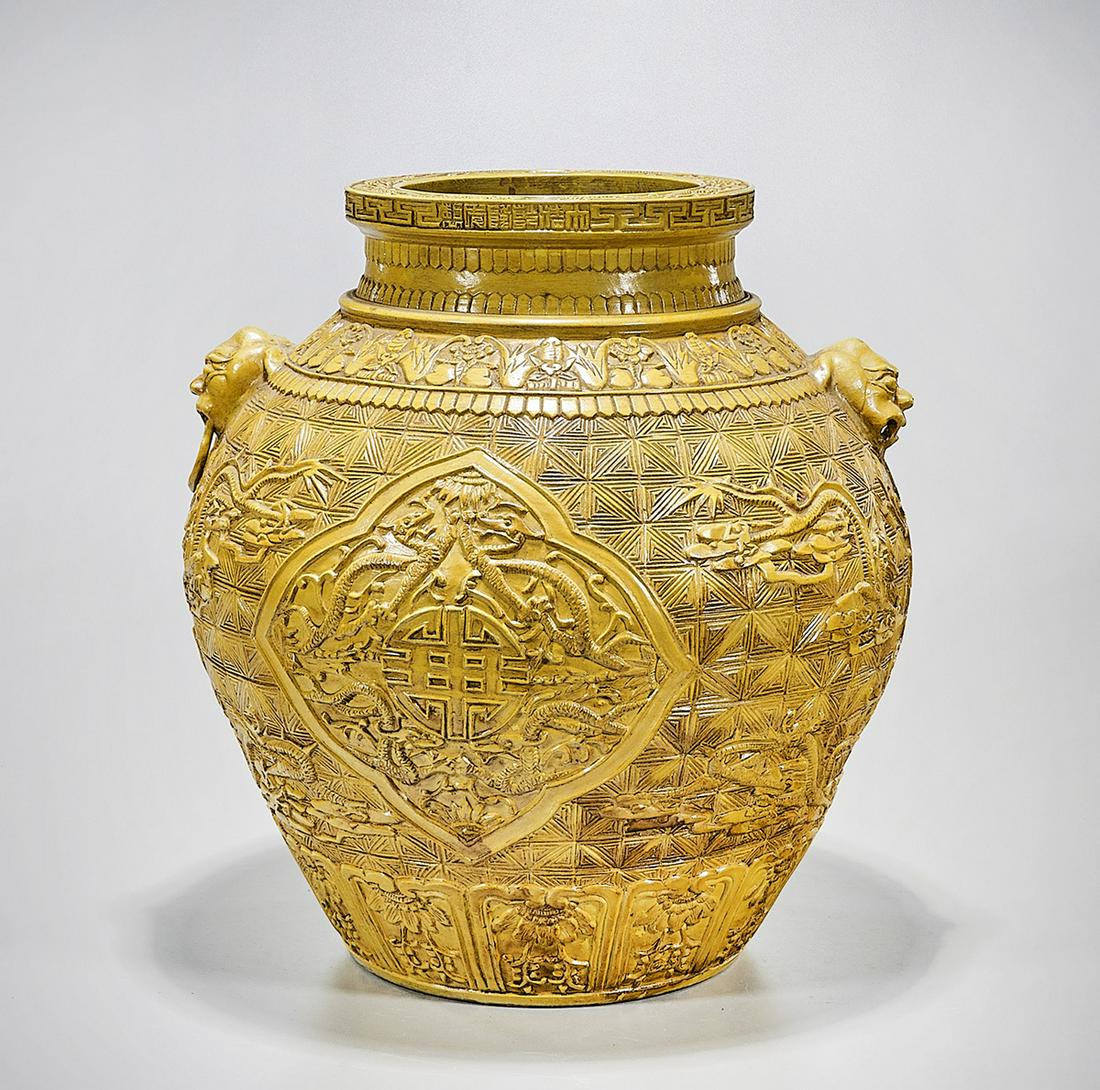 Chinese Glazed Porcelain Vase: Chinese yellow glazed porcelain vase; molded relief dragons chasing pearls and shou character design; 16" x 15 1/2" (approx.) Condition: wear, frits, pits, minor loss