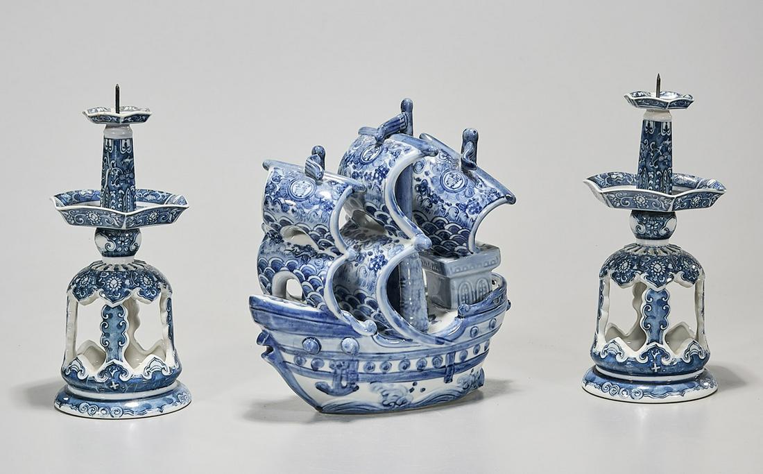 Three Japanese Blue and White Porcelains: Three Japanese blue and white porcelains; including a ship and two candlesticks; 10" x 4" (largest, approx.) Condition: wear, minor losses