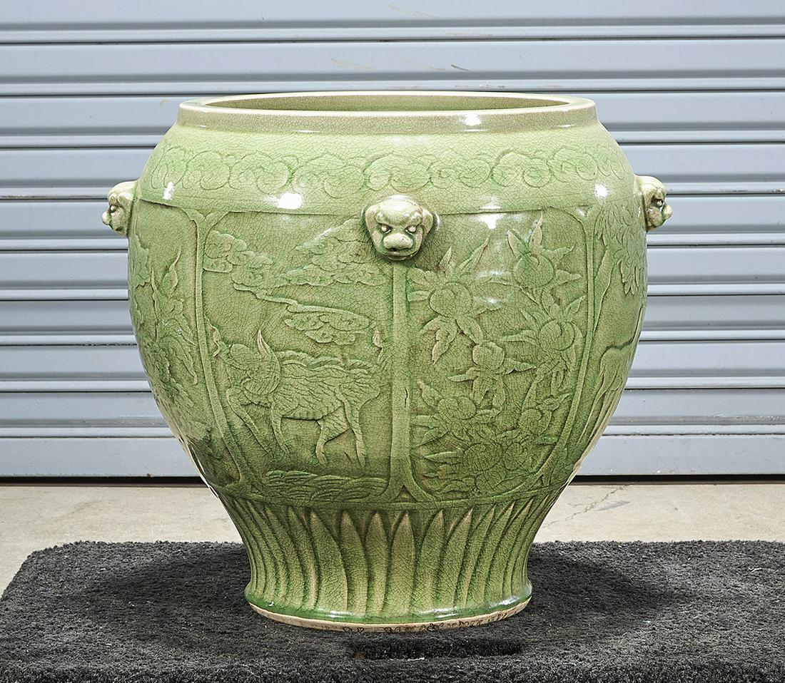 Chinese Green Crackle Glazed Porcelain Jardiniere: Chinese green crackle glazed porcelain jardiniere; deer and floral relief design; 16" x 21" (approx.) Condition; wear, frits, pits, minor loss