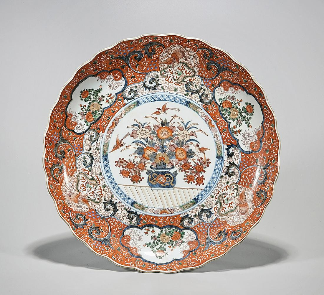 Japanese Red, Blue and White Porcelain Charger: Japanese glazed porcelain scalloped rim charger; red, blue and white flower decoration; D: 17" (approx.) Condition: wear, minor loss