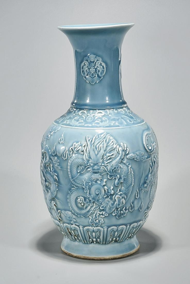 Chinese Blue Glazed Porcelain Vase: Chinese blue glazed porcelain vase; depicting dragons chasing pearls in relief; mark to base; 17" x 8 1/2" (approx.) Condition: wear, frits, pits, minor loss