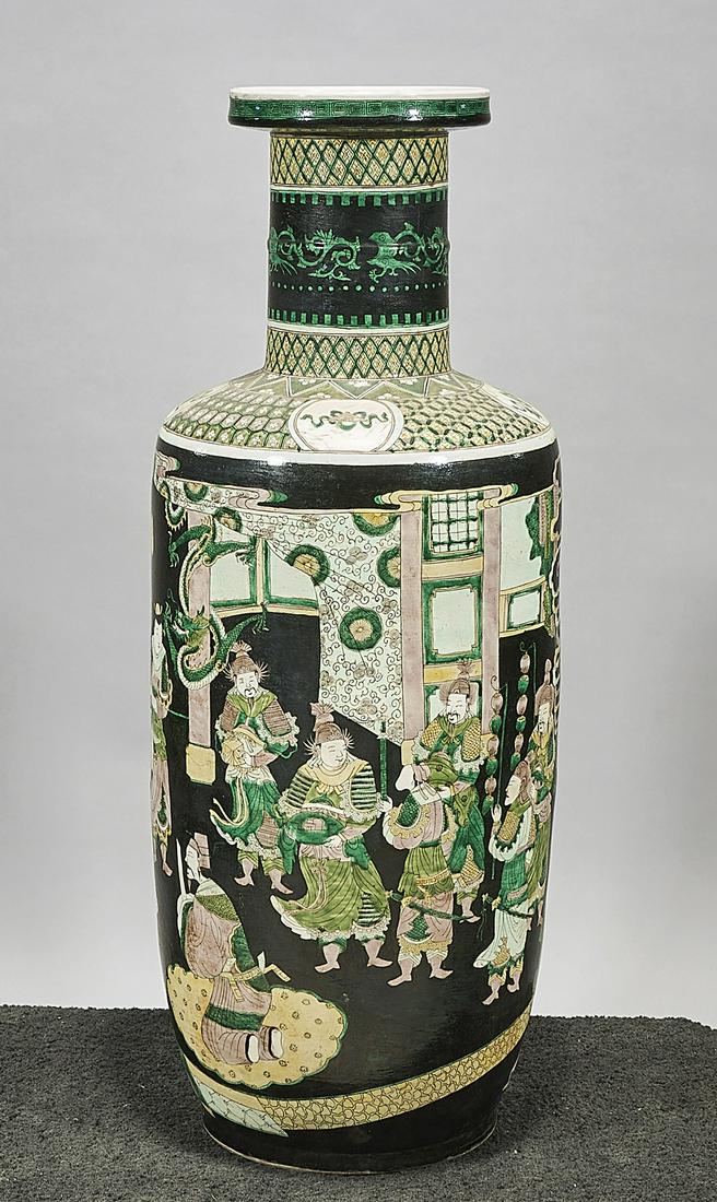 Tall Chinese Famille Verte Porcelain Vase: Tall Chinese famille verte porcelain vase; depicting figures in an interior, reserved on black ground; 37" x 14" (approx.) Condition: wear, frits, pits, minor loss