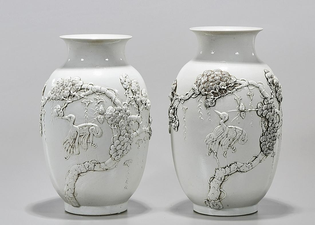 Pair Chinese White Glazed Porcelain Vases: Pair of Chinese white glzed porcelain vases; with molded tree and bird decoration; 12" x 7" (each, approx.) Condition: wear, frits, pits, minor losses