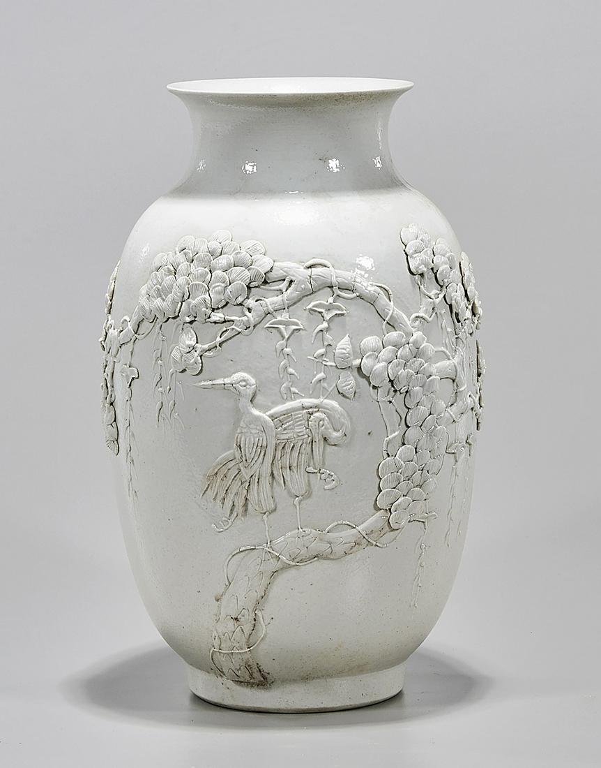 Chinese White Glazed Porcelain Vase: Chinese white glazed porcelain vase; with molded tree and bird design; 12" x 7" (approx.) Condition: wear, minor losses
