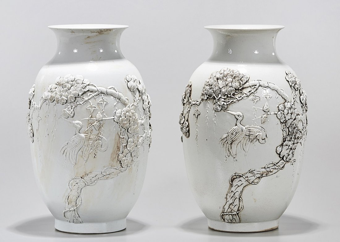 Pair Chinese White Glazed Porcelain Vases: Pair of Chinese white glazed porcelain vases; with molded tree and bird design; 12" x 7" (each, approx.) Condition: wear, minor losses
