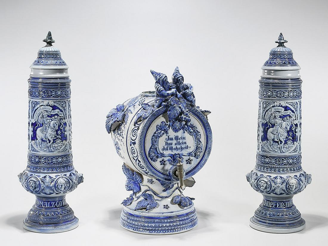 Blue and White Ceramic German-Style Model Beer Stein: Blue and white ceramic German-style model beer steins and keg; 21 1/2" x 7" (tallest, approx.) Condition: wear, minor losses, crack restoration