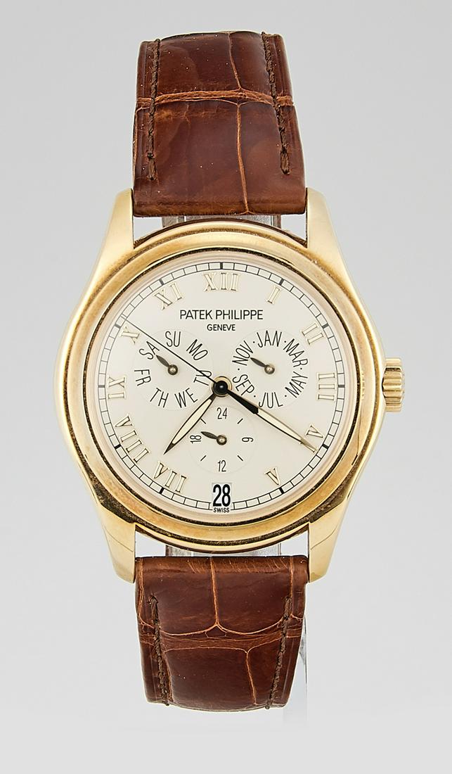 PATEK PHILIPPE 5035J ANNUAL CALENDAR: Patek Philippe 18K Yellow Gold Annual Calendar Watch (Ref. 5035J) collector's set with Certificate of Origin, two straps, original Box with both inner and outer, tool and leather portfolio with paperw