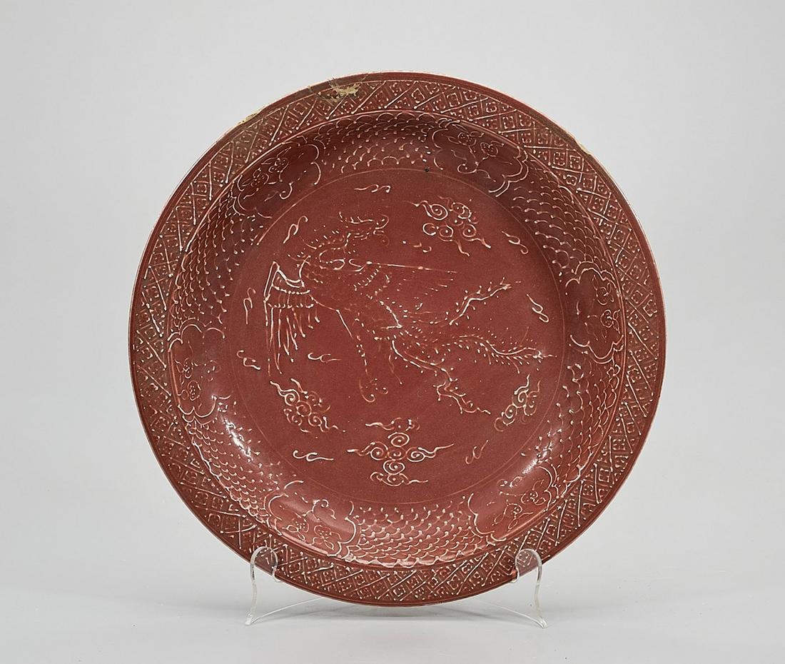 Chinese Glazed Porcelain Charger: Chinese red glazed porcelain charger; low relief design dragon chasing pearls; 2 3/8" x 13 1/2" (approx.) Condition: repair, wear, frits, pits, minor loss
