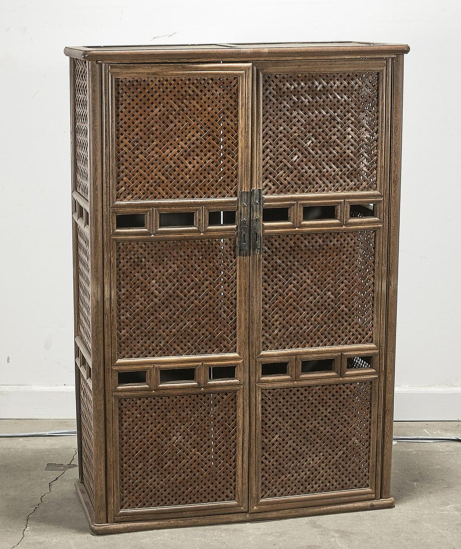 Chinese Bamboo and Wood Cabinet: Chinese wood cabinet with two doors and three interior shelves; bamboo lattice sides and front design; 46" x 32" x 13 1/2" (approx.) Condition: wear, losses